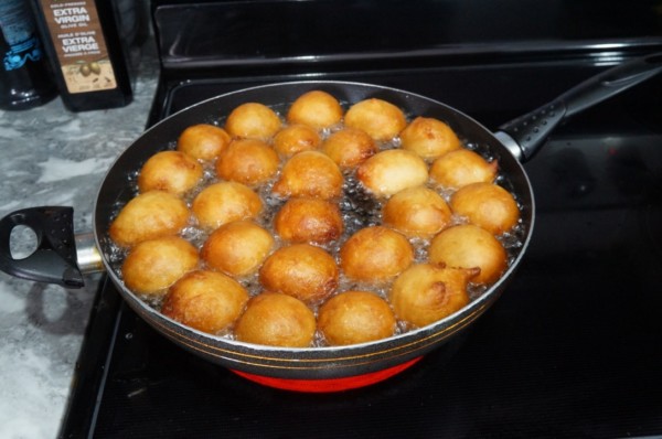 Puff puff in oil on stove frying 