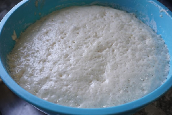 Nigerian puff puff dough in a blue bowl after rising 